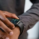 A detailed view of a smartwatch tracking fitness on a person's wrist.